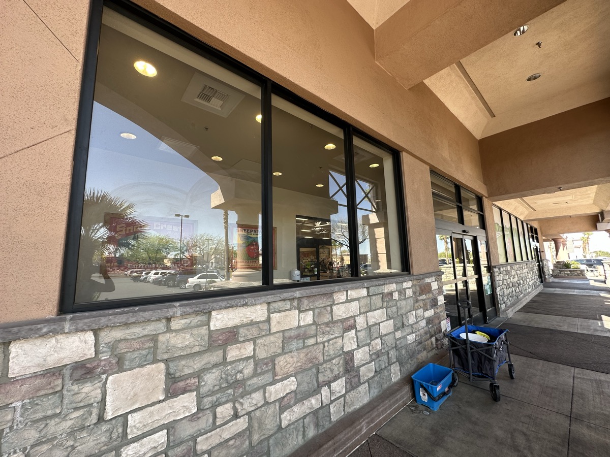 Shopping center storefront window cleaning with professional equipment in Las Vegas