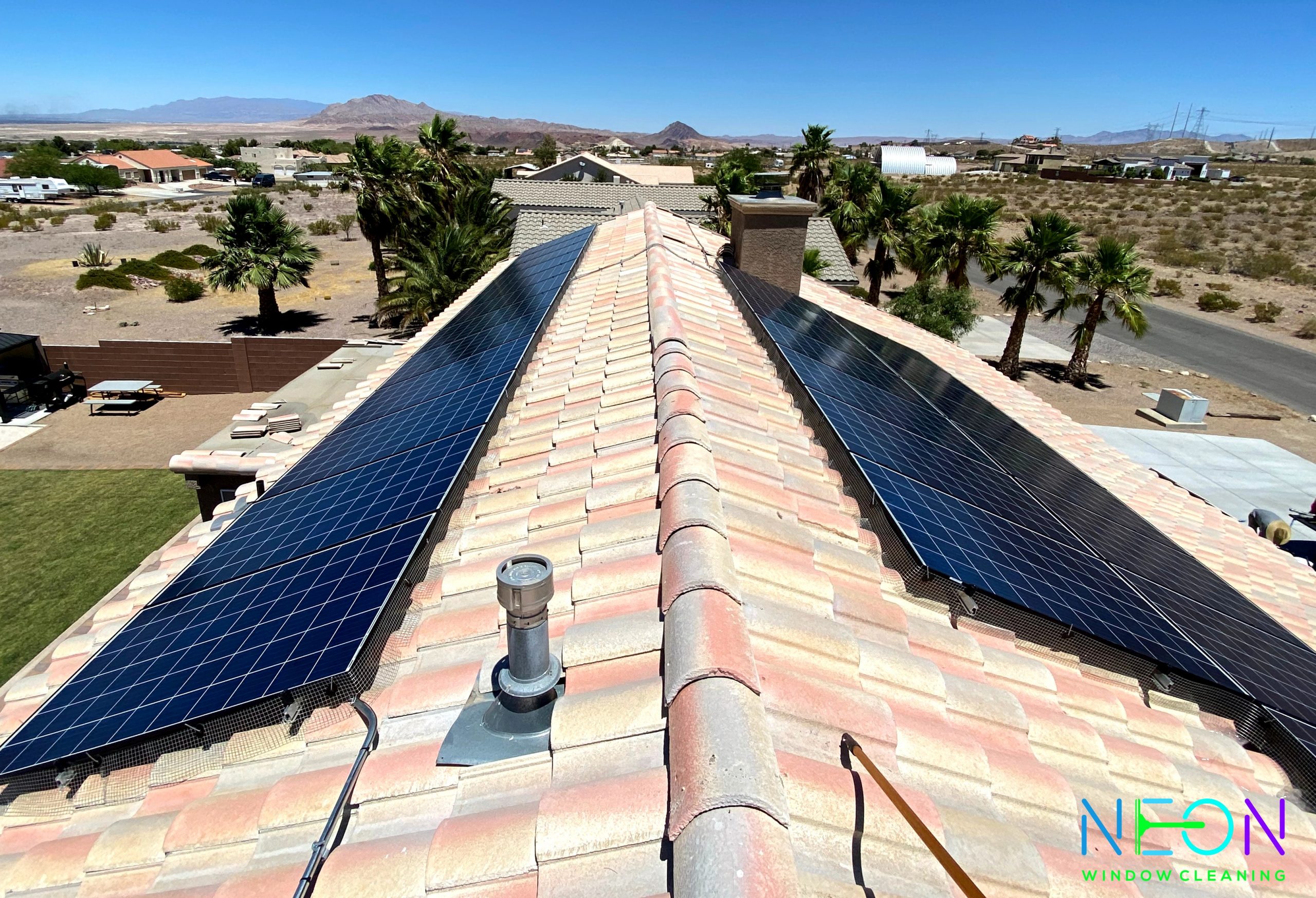 Clean solar panels on a Summerlin rooftop with Red Rock Canyon visible in the background